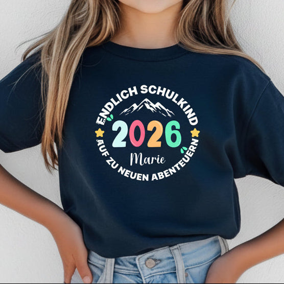 Cooles Schulkind T-Shirt 2026 mit Abenteuer Motiv, perfekt für Jungen und Mädchen zur Einschulung. Ideal als Geschenk zum Schulanfang für Kinder, die mit Stil in die 1. Klasse starten. Das T-Shirt zur Einschulung besteht aus 100 % Bio-Baumwolle und kann mit Namen personalisiert werden. Perfekt als Einschulung Shirt Junge, T-Shirt endlich Schulkind, Geschenk Einschulung Kind, T-Shirt für Erstklässler oder Bye Bye Kindergarten Geschenk. Dieses Einschulungsshirt bringt Vorfreude auf den Schulstart