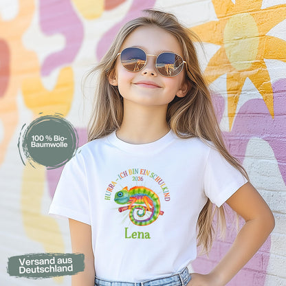 Cooles Schulkind T-Shirt 2026 mit Chamäleon-Motiv, perfekt für Jungen zur Einschulung. Ideal als Geschenk zum Schulanfang für mutige Kinder, die mit Stil in die 1. Klasse starten. Das T-Shirt zur Einschulung besteht aus 100 % Bio-Baumwolle und kann mit Namen personalisiert werden. Perfekt als Einschulung Shirt Junge, T-Shirt endlich Schulkind, Geschenk Einschulung Kind, T-Shirt für Erstklässler oder Bye Bye Kindergarten Geschenk. Dieses Einschulungsshirt bringt und Vorfreude auf den Schulstart