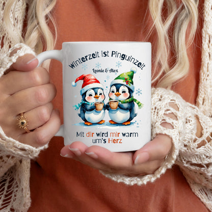 Personalisierte Weihnachtstasse mit zwei süßen Pinguinen, Herz-Spruch und winterlicher Szene – ideal als Geschenk Weihnachten für Freundin, Freund, Partner oder Familie. Wintertasse mit Namen und Spruch „Mit dir wird mir warm ums Herz“. Hochwertiger Keramikbecher mit liebevollem Pinguin-Motiv, perfekt als Nikolausgeschenk, kleines Weihnachtsgeschenk oder Wichtelgeschenk. Geschenkidee für Paare, Männer oder Frauen – romantisch, witzig und emotional. Weihnachtsbecher mit Namen online gestalten.