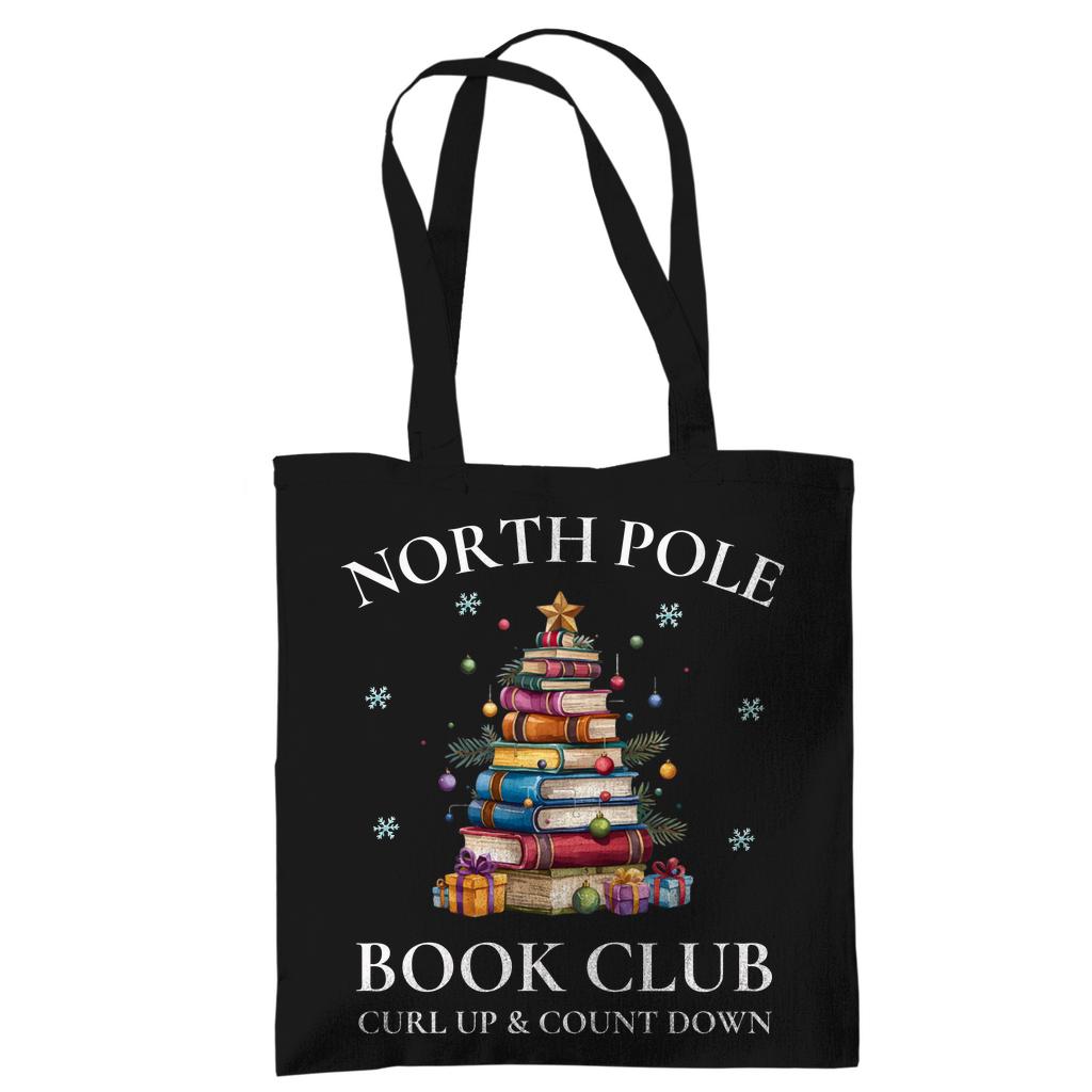 Baumwoll-Stofftasche mit weihnachtlichem Motiv: Ein Bücherbaum mit Stern und Geschenken symbolisiert den „North Pole Book Club“. Perfekt als Jutebeutel Weihnachten für Leseratten, Bücherfreunde, Bibliophile oder Buchclub-Mitglieder. Ideales Geschenk für Buchliebhaber und als nachhaltige Geschenkverpackung mit Buchthema zur Adventszeit. Baumwolltasche für Weihnachten & Buchfans. WeihnachtsStofftasche für Bücherfreunde! Der Jutebeutel ist das perfekte Geschenk für Buchliebhaber zur Adventszeit.
