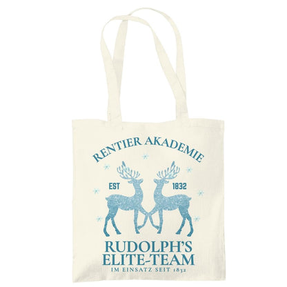Weihnachtliche Stofftasche mit Rentier-Motiv „Rentier Akademie – Rudolph’s Elite-Team“ im Vintage-Stil. Ideale Baumwolltasche für Weihnachten, Einkäufe, Geschenke oder als nachhaltiger Jutebeutel. Perfekt als Geschenkidee oder als wiederverwendbare Geschenktasche mit Weihnachtsdesign. Waschbar, langlebig, mit langen Henkeln – als Weihnachtsgeschenktasche, Stoffbeutel oder Einkaufstasche nutzbar. Ideal für Damen, Herren oder Kinder zur Weihnachtszeit. Farben: Natur, Blau, Schwarz.