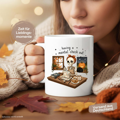 Halloween Tasse mit Spruch „having a mental check out“ und lustigem Skelett am Schreibtisch als Halloween Geschenk und Geschenk für Freundin oder Kollegin. Weiße Keramiktasse 330 ml beidseitig bedruckt mit Skelett, Kalender, Kaffee, Keksen, schwarzer Katze, Kürbis und Herbstblättern. Humorvolle Skelett Tasse für Spooky Season und Herbstzeit, ideal als lustiges Geschenk für Halloweenfans, beste Freundin, Schwester und Kollegin. Halloween Tasse, Mental Load Tasse, Lustige Tasse Kollegin